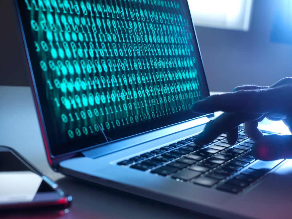 Cyber Crime, laptop computer being hacked